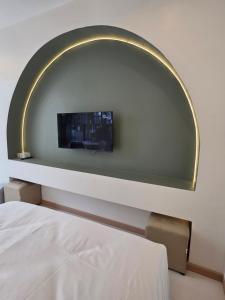 a room with a bed and a tv on a wall at Villa38  +14 photos