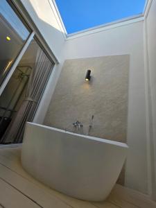 a white bath tub in a room with a window at Villa38 