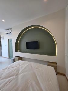 a bedroom with a flat screen tv on a wall at Villa38 