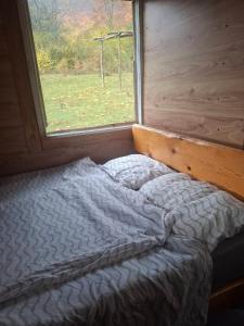 a bed in a room with a window at CASA Petra in Bituše