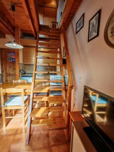 a wooden staircase in a room with a table and a dining room at Dúplex rústico familiar- Amplitud y vistas espectaculares - Cuc 2 in Pla de l'Ermita +13 photos