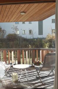 um pátio com uma cadeira e uma mesa num deque em Motta Rotonda em Maloja