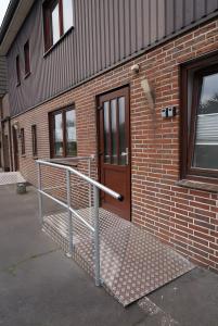 a brick building with a ramp next to a door at Schöne Monteurs Wohnung 6 in Wesseln