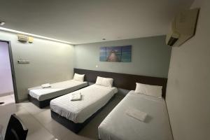 Ένα ή περισσότερα κρεβάτια σε δωμάτιο στο Tiong Nam Hotel