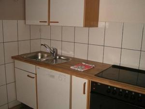 a kitchen with a sink and a stove at Tolle Wohnung In Ober Roden in Rödermark