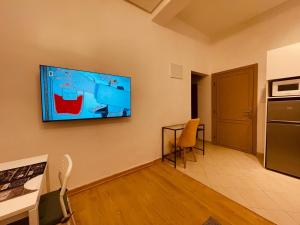 a living room with a flat screen tv on the wall at Relax Family 01 - Cozy Entire Apartement in City Center in Ouarzazate