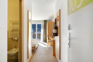 a bathroom with a sink and a toilet in a room at Kreativ Hotel Landhaus Schweigl in Ultimo +282 photos