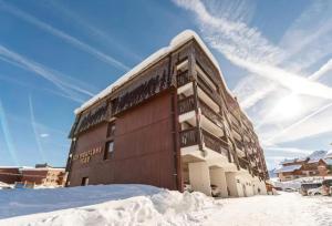 普拉茲德里斯Studio moderne à Taninges avec vue sur les montagnes - 35 m²的前面的地面上积雪的建筑