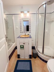 a bathroom with a sink and a shower and a mirror at Casa Roma in Raposeira +48 photos