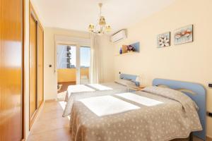 a bedroom with two beds and a window at Beachfront penthouse in La Manga in San Blas +18 photos