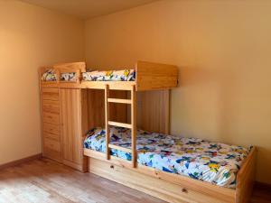 a bedroom with two bunk beds and a wooden cabinet at Doble balcón, máxima luz- Confort de qualidad - Erta 5 in Pla de l'Ermita