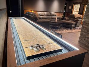 a ping pong table in a living room at Mountain Hideaway - Hot Tub, Fire Pit, Close to Town in Ellijay