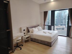 a bedroom with a bed and a desk and a window at Star Infinity Pool At Klcc in Kuala Lumpur +56 photos