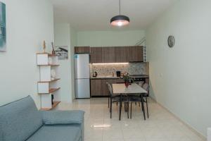a living room with a blue couch and a table at Luxury Apartment with Parking in Tirana