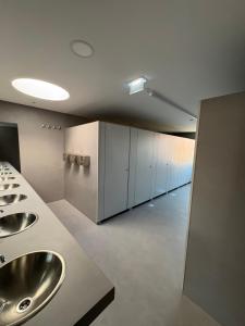 a bathroom with two sinks and a row of cabinets at Angeiras Beach Hostel in Lavra