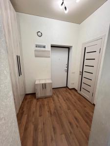 an empty room with a door and a wooden floor at Apartment in the center in Bishkek