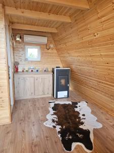a living room with a tv in a log cabin at A Frame la Iaz in Mărăcineni