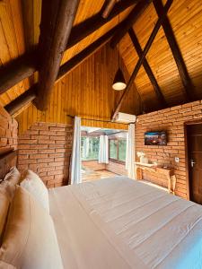 a bedroom with a large bed in a room at Maria Rita dos Canyons in Praia Grande +54 photos