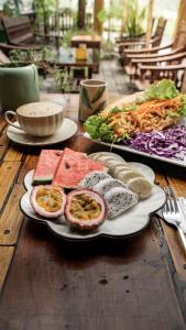 a wooden table with two plates of food on it at Trang xinh homestay Tam coc 