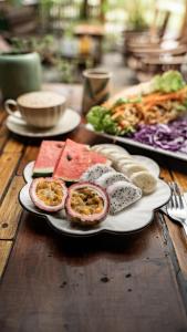 a plate of food on a wooden table at Trang xinh homestay Tam coc  +44 photos
