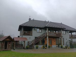 a large white house with a gambrel roof at Sopko rest in Svityazʼ