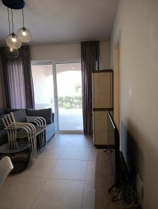 a living room with a couch and a table at Apartment Odysea in Plataniás