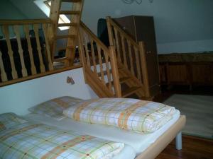 a bed with two pillows on it in a room at Ferienwohnung In Ehemaliger Dorfschule Am Dorfrand in Bergen +15 photos