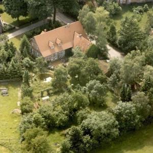 an aerial view of a large house with trees at Ferienwohnung In Ehemaliger Dorfschule Am Dorfrand in Bergen