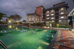a swimming pool in front of a building at night at Himalayan Gateway By Dept Of Tourism, GTA in Jāmb