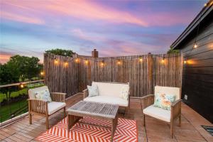 a patio with chairs and a table and a fence at Modern Lakeside Paradise - Waterfront 2 Patios home in Mabank