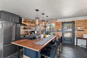 a kitchen with a wooden counter top and a kitchen island at Modern Lakeside Paradise - Waterfront 2 Patios home in Mabank