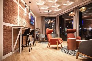 a restaurant with chairs and a brick wall at B&B HOTEL Krakow Centrum in Kraków