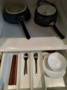 Ein Tisch mit Besteck auf einem Regal in der Unterkunft Yifang Apartment in Hangzhou