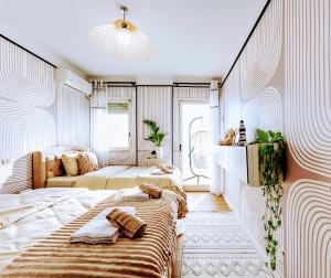 a bedroom with two beds and a chandelier at Beachfront Boutique Apartments in Durrës +101 photos