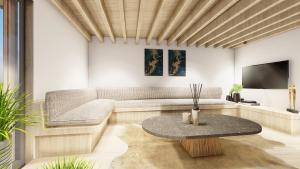 a living room with a couch and a table at OakstoneLodge- Gite avec Jacuzzi Piscine et Sauna in Houyet