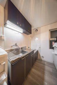 a kitchen with a sink and a counter top at mikiHOTEL本川町303 in Hiroshima