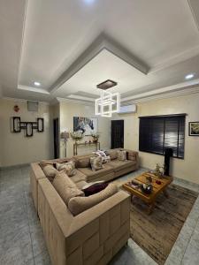 a living room with a couch and a table at Exotic Modern 2BR Apartment in Independence Layout in Enugu
