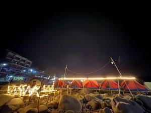 a group of tents on a beach at night at Front view campsite in Shillong +2 photos