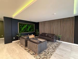 a living room with two couches and a flat screen tv at Bright warm & spacious 1 BR in North End Halifax in Halifax