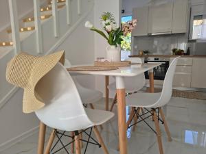 a kitchen with a white table and white chairs at Rodini Home Ylia - Rhodes in Rhodes Town +24 photos