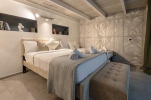 a bedroom with a large bed and a bench in it at DrsRome - Colosseum Loft in Rome