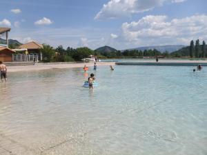 a group of people in the water at a beach at Les Terrasses du Paradis in Orpierre