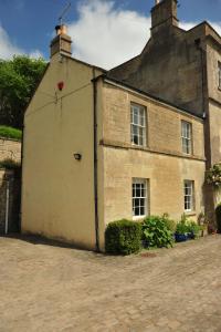 un vieux bâtiment en briques avec une porte sur son côté dans l'établissement Victorian Annexe - Bath, à Bath