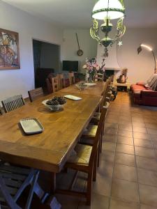 a large wooden table with chairs and a dining room at Villa Ecluses Mediterranee in Portiragnes