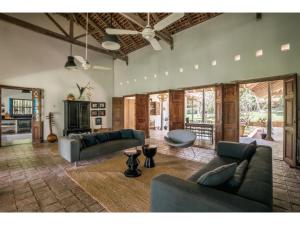 a living room with two couches and a table at Dutch house 5 bedrms pool chef in Habaraduwa Central