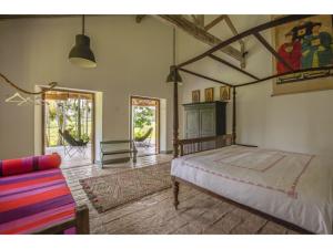 a bedroom with a bed and a couch at Dutch house 5 bedrms pool chef in Habaraduwa Central +39 photos