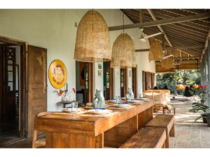 a long counter in a restaurant with tables and chairs at Dutch house 5 bedrms pool chef in Habaraduwa Central