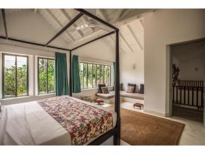 a bedroom with a bed and a couch at Wijaya Giri walkable to beach pool chef in Ahangama +35 photos