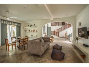a living room with a couch and a dining room at Wijaya Giri walkable to beach pool chef in Ahangama