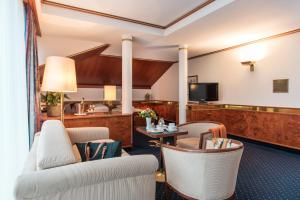 una stanza d'albergo con sedie e una tv di Bad Horn - Hotel & Spa a Horn